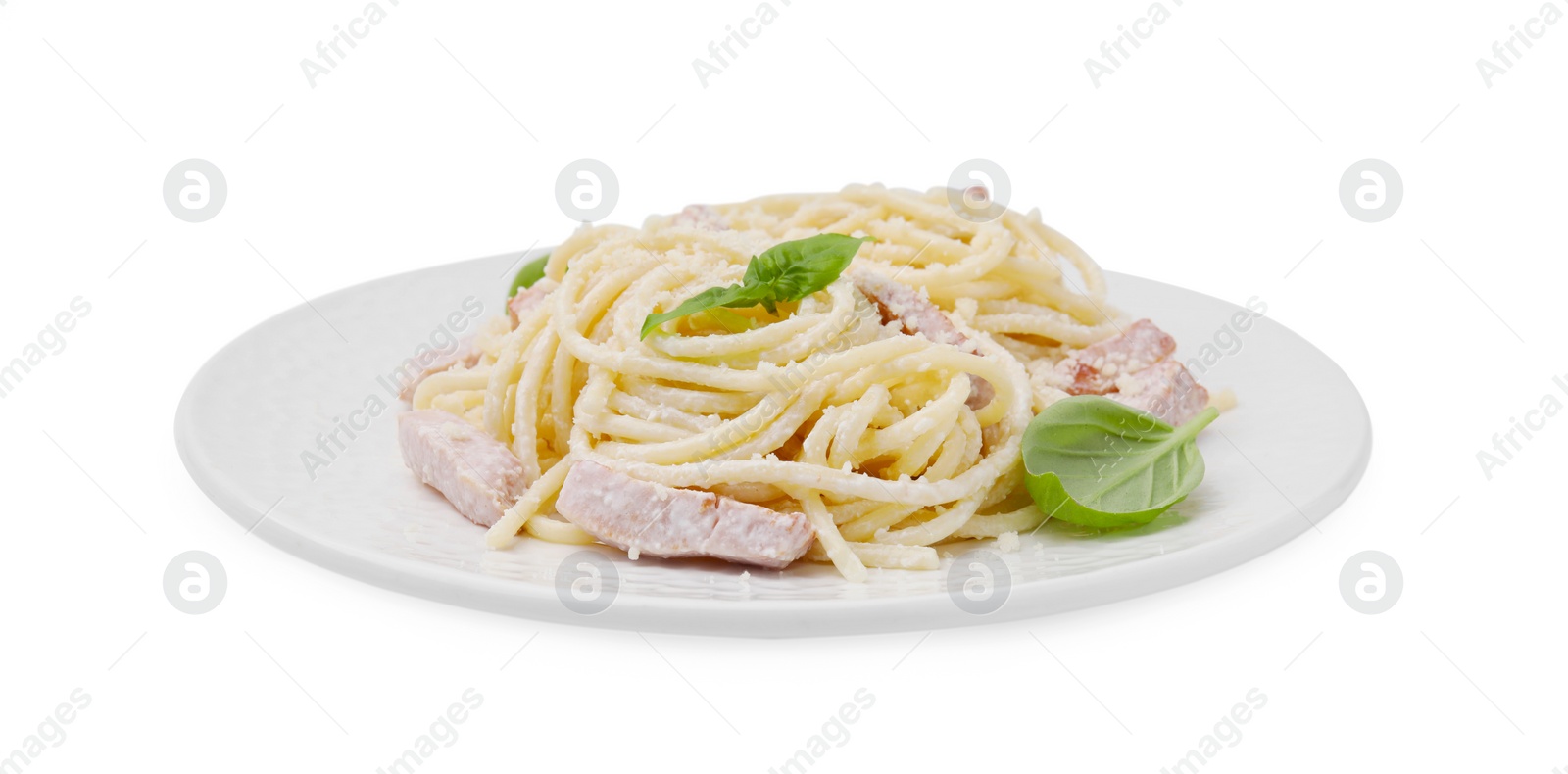 Photo of Plate of tasty pasta Carbonara with basil leaves isolated on white