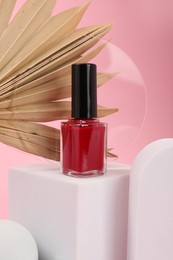 Photo of Stylish presentation of nail polish on pink background