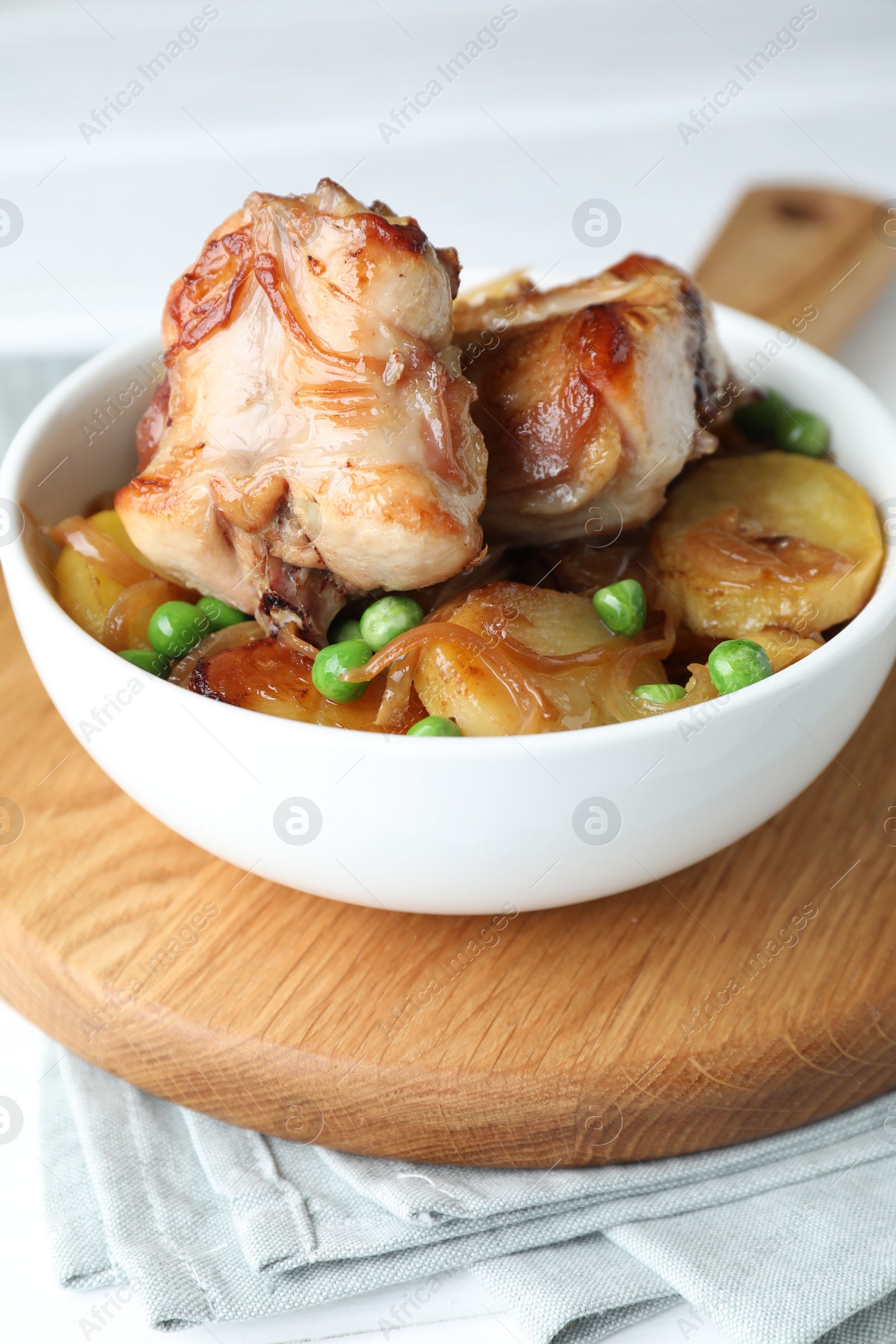 Photo of Tasty cooked rabbit with vegetables in bowl on table, closeup