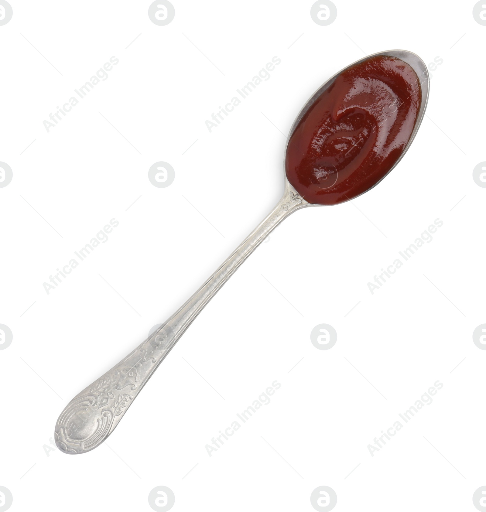 Photo of Tasty barbecue sauce in spoon isolated on white, top view