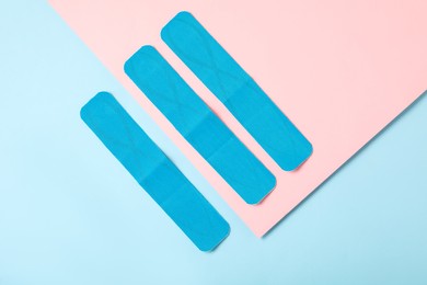 Photo of Bright kinesio tape pieces on color background, flat lay