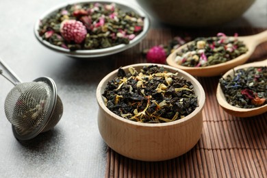 Photo of Different herbal teas on grey table, closeup