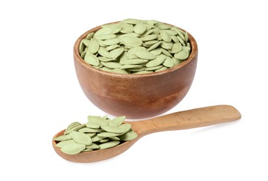 Wooden bowl and spoon with pumpkin seeds isolated on white