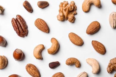 Composition with organic mixed nuts on white background, top view