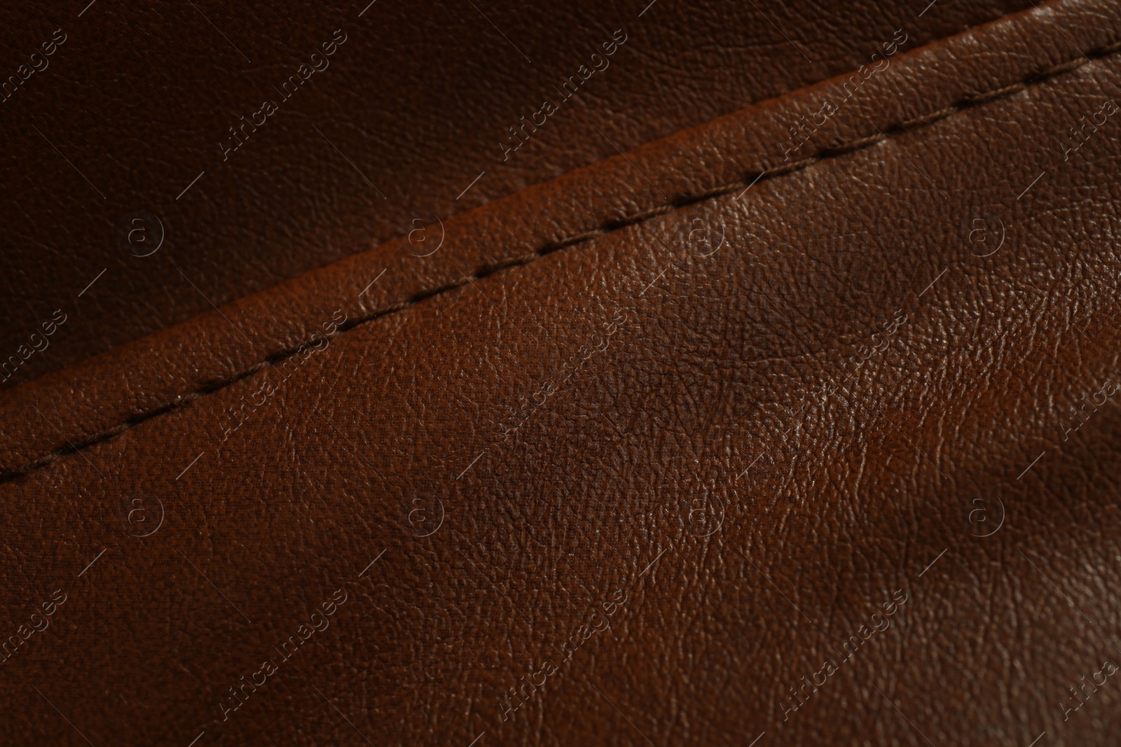 Photo of Brown leather with seam as background, above view