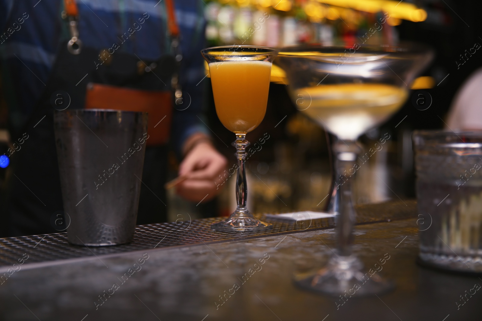 Photo of Glass of tasty cocktail on bar counter