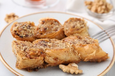 Photo of Eastern sweets. Pieces of tasty baklava on table, closeup