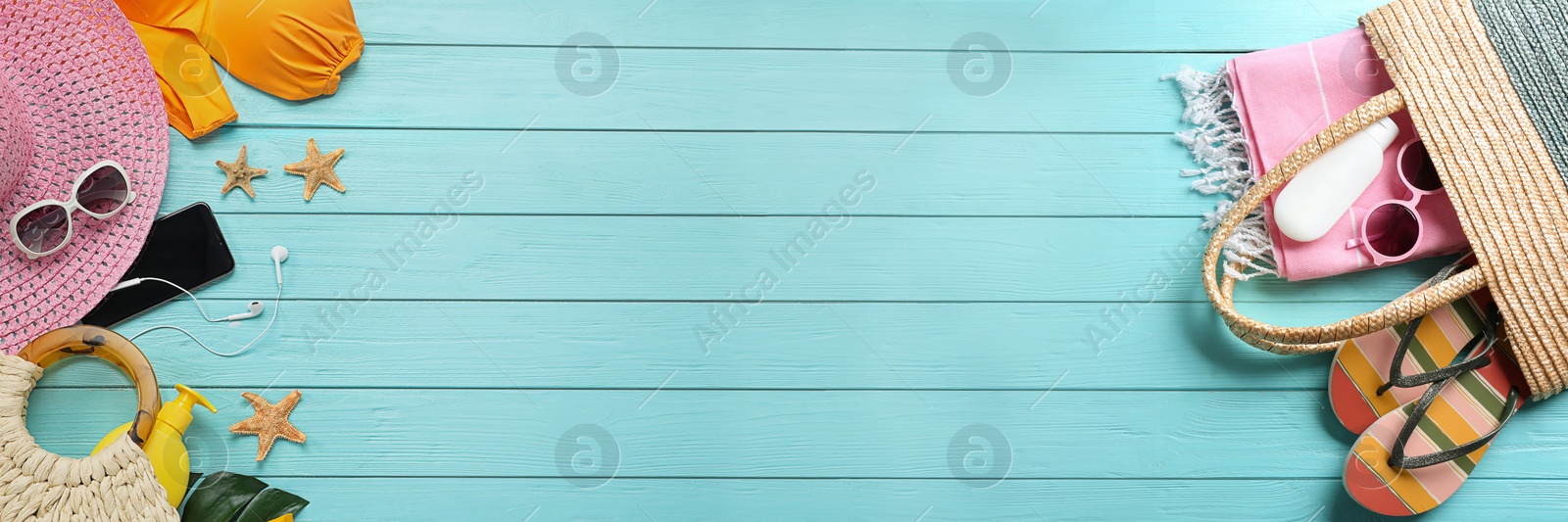 Image of Flat lay composition with beach accessories on light blue wooden background, space for text. Banner design