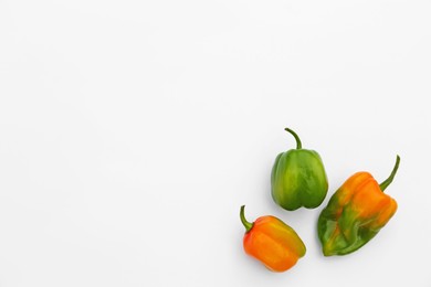 Different fresh raw hot chili peppers on white background, flat lay. Space for text