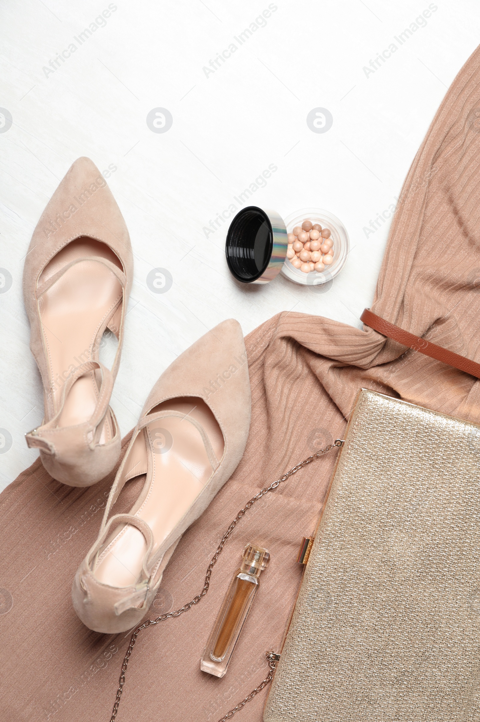 Photo of Flat lay composition with beige lady's shoes on white wooden table
