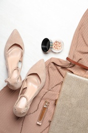 Flat lay composition with beige lady's shoes on white wooden table