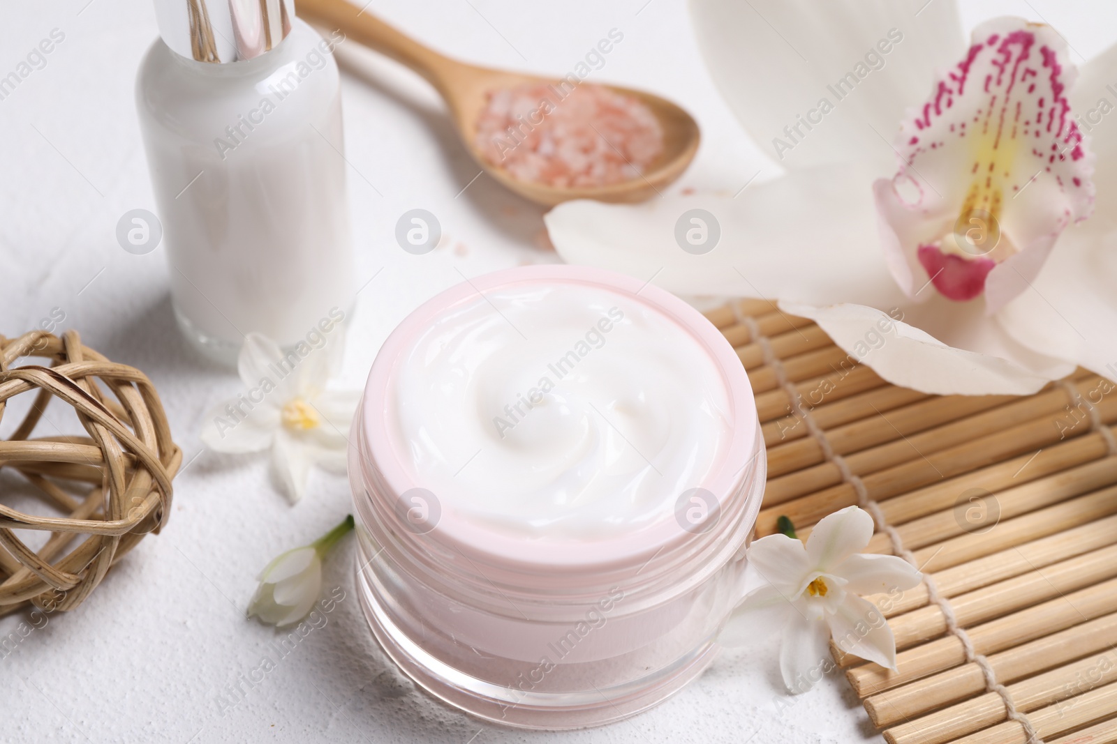 Photo of Beautiful spa composition with cosmetic products and flowers on white table