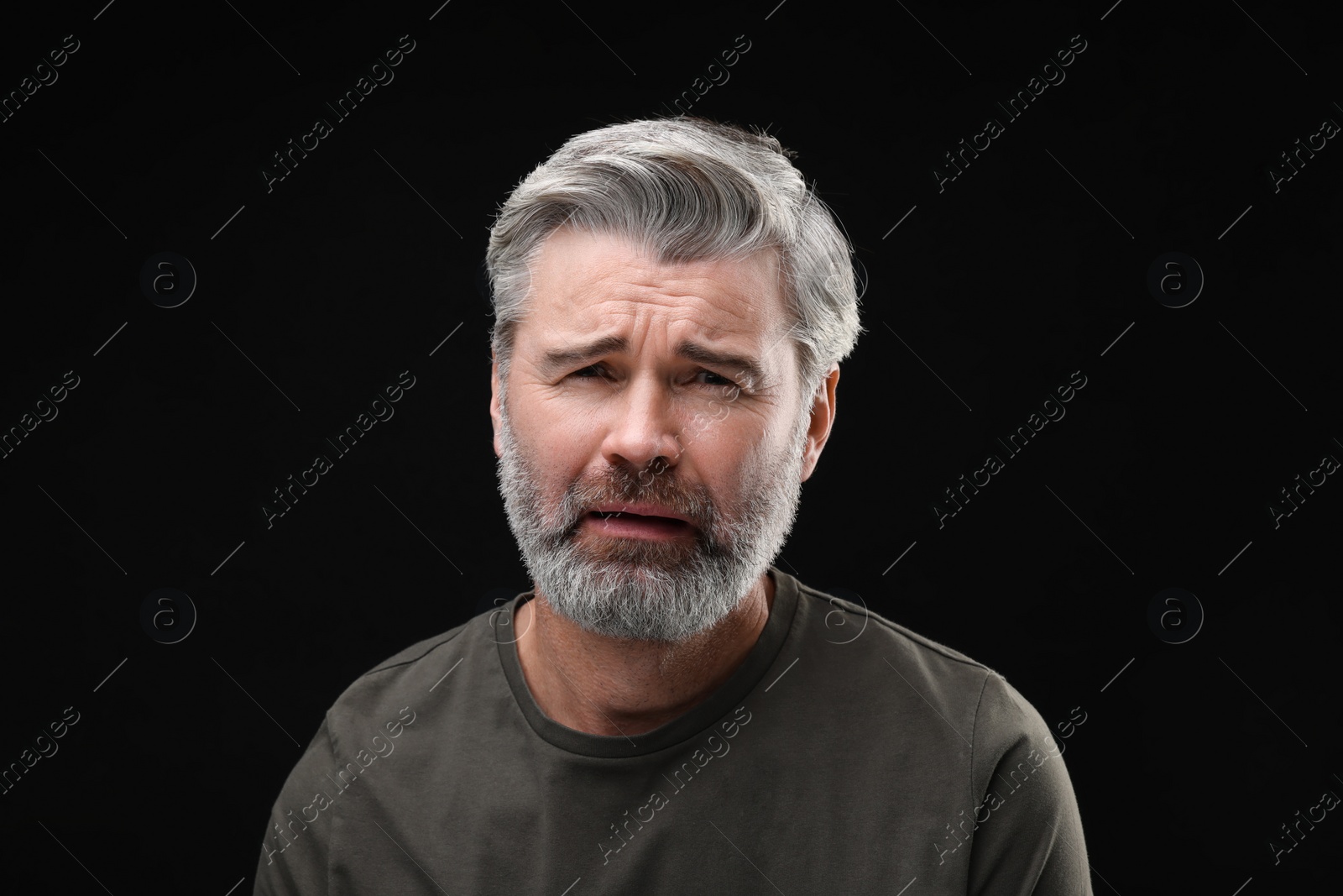 Photo of Personality concept. Portrait of emotional man on black background