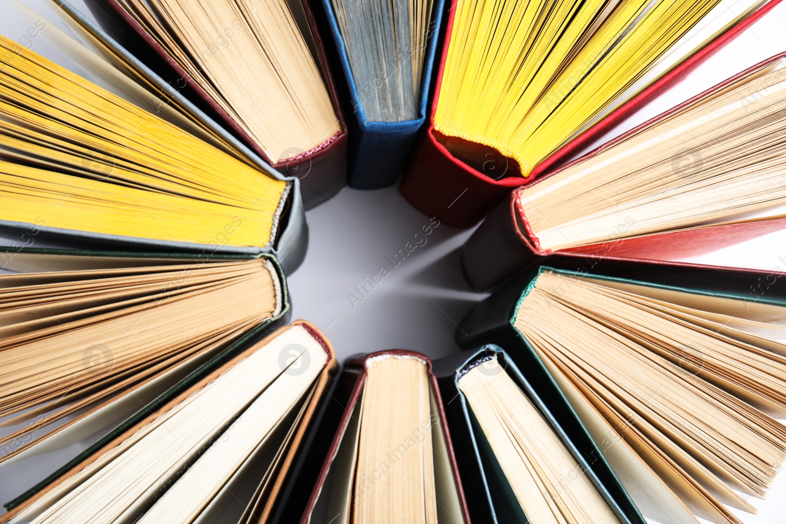 Photo of Circle made of hardcover books on white background, flat lay