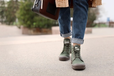 Young woman in comfortable casual shoes walking on street