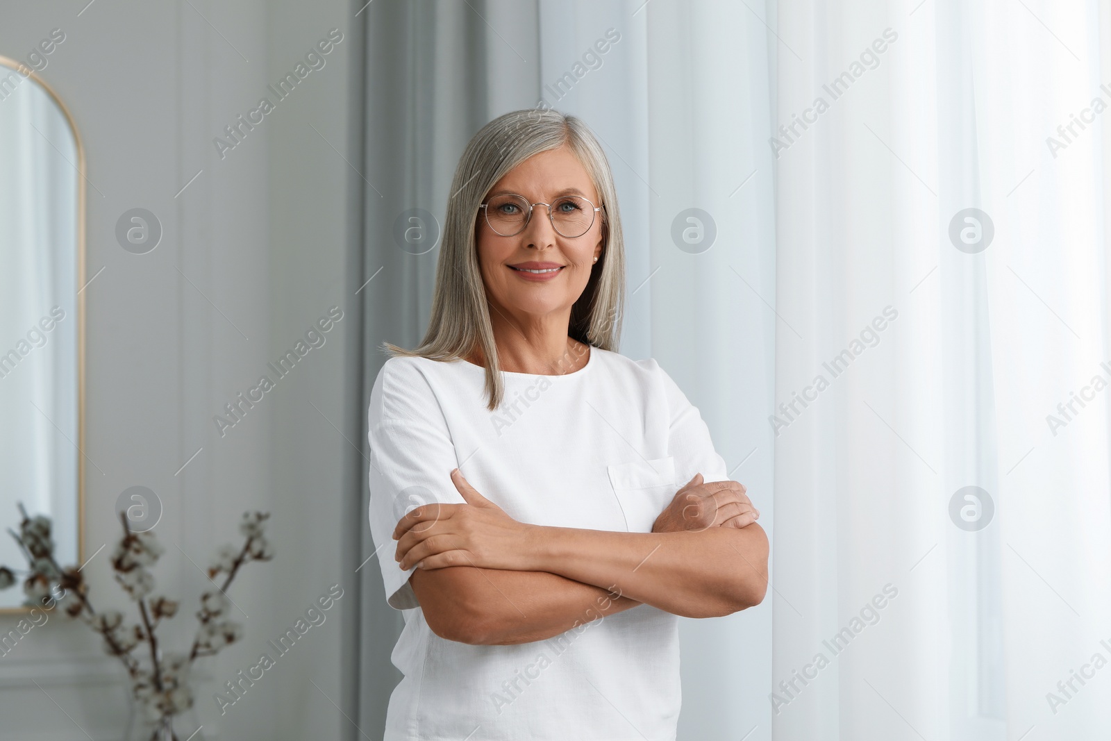 Photo of Portrait of beautiful middle aged woman in eyeglasses indoors