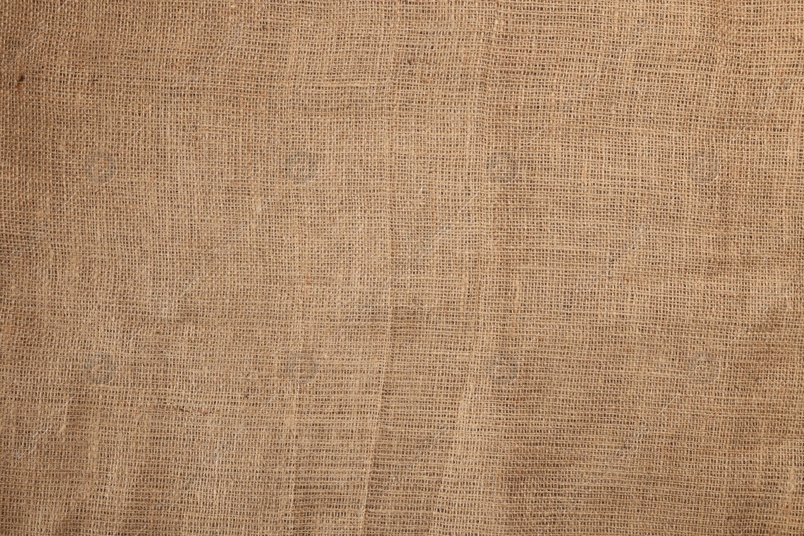 Photo of Texture of natural burlap fabric as background, top view