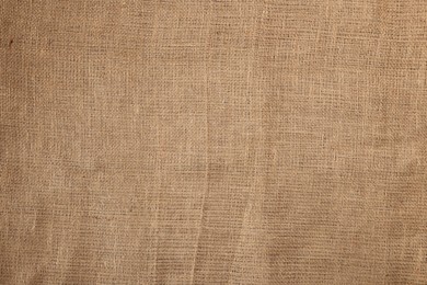 Texture of natural burlap fabric as background, top view