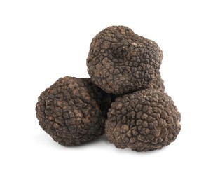 Photo of Fresh whole black truffles isolated on white