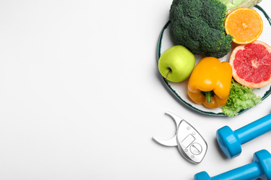Photo of Fruits, vegetables, dumbbells and caliper of products on white background, top view. Visiting nutritionist