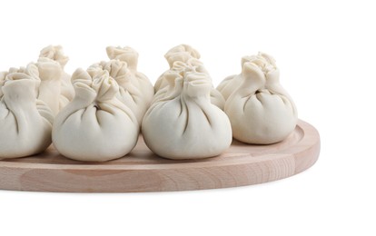 Wooden board with uncooked khinkali (dumplings) isolated on white. Georgian cuisine