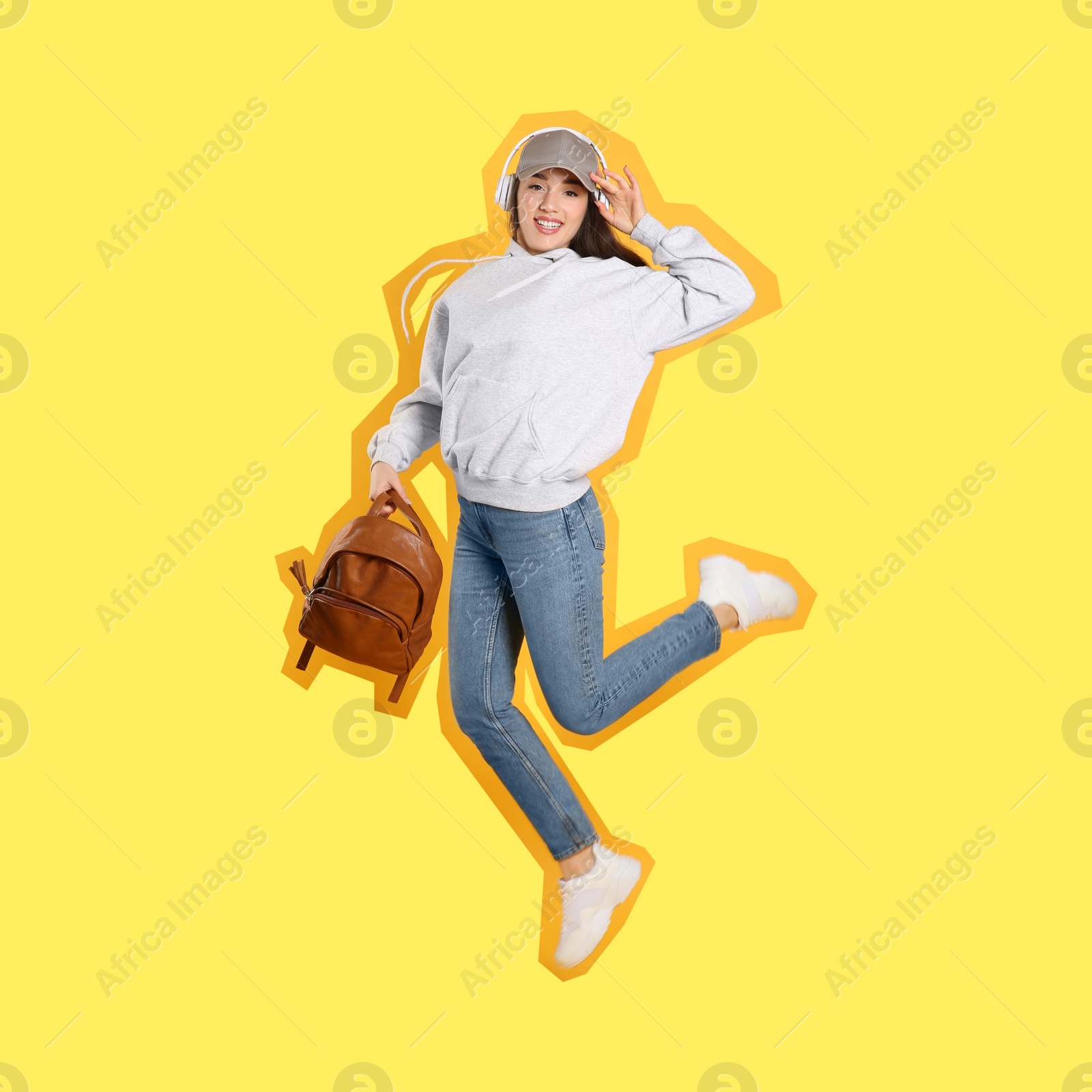 Image of Pop art poster. Beautiful young woman with stylish leather backpack and headphones jumping on yellow background