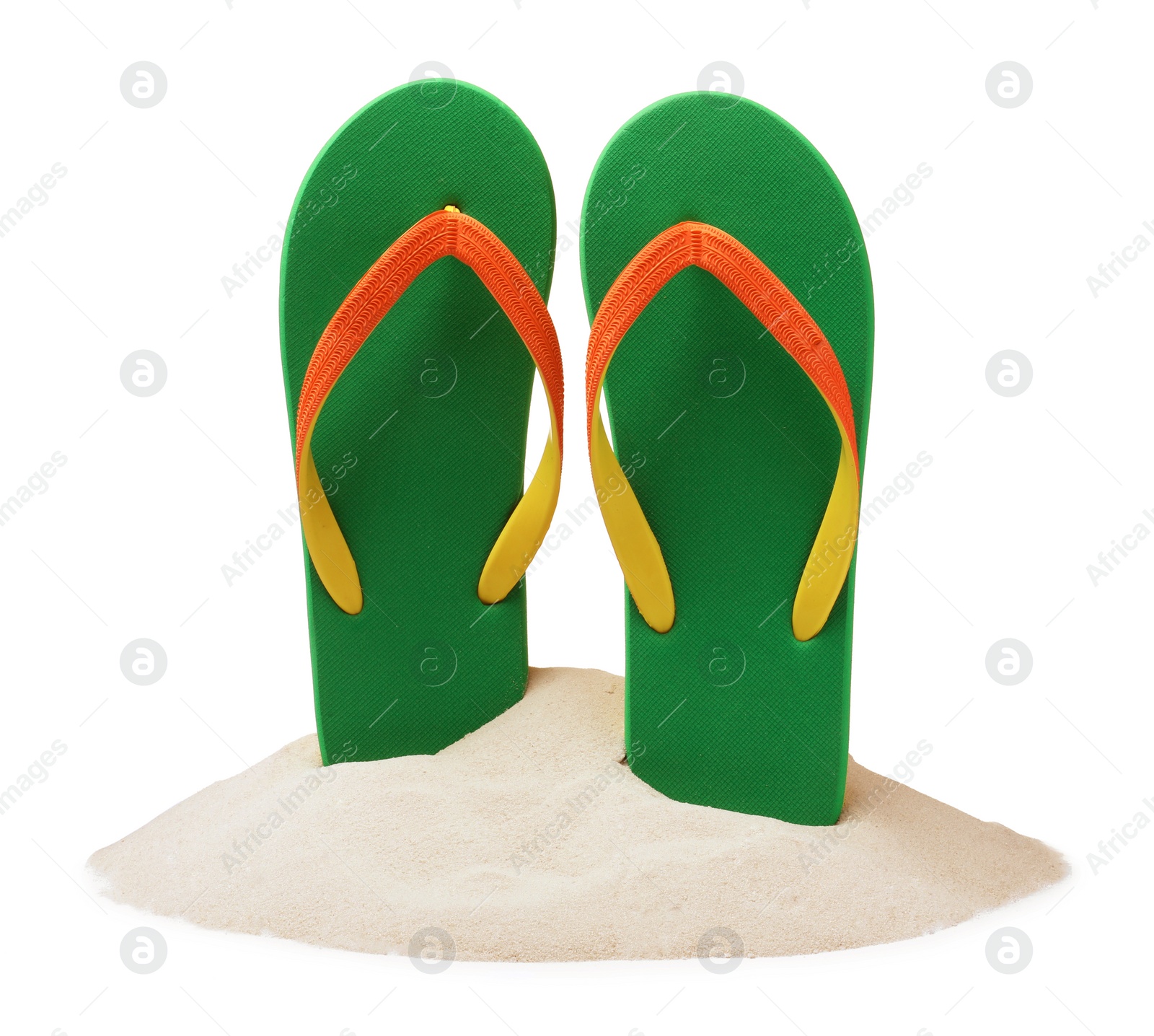 Photo of Green flip flops in sand on white background