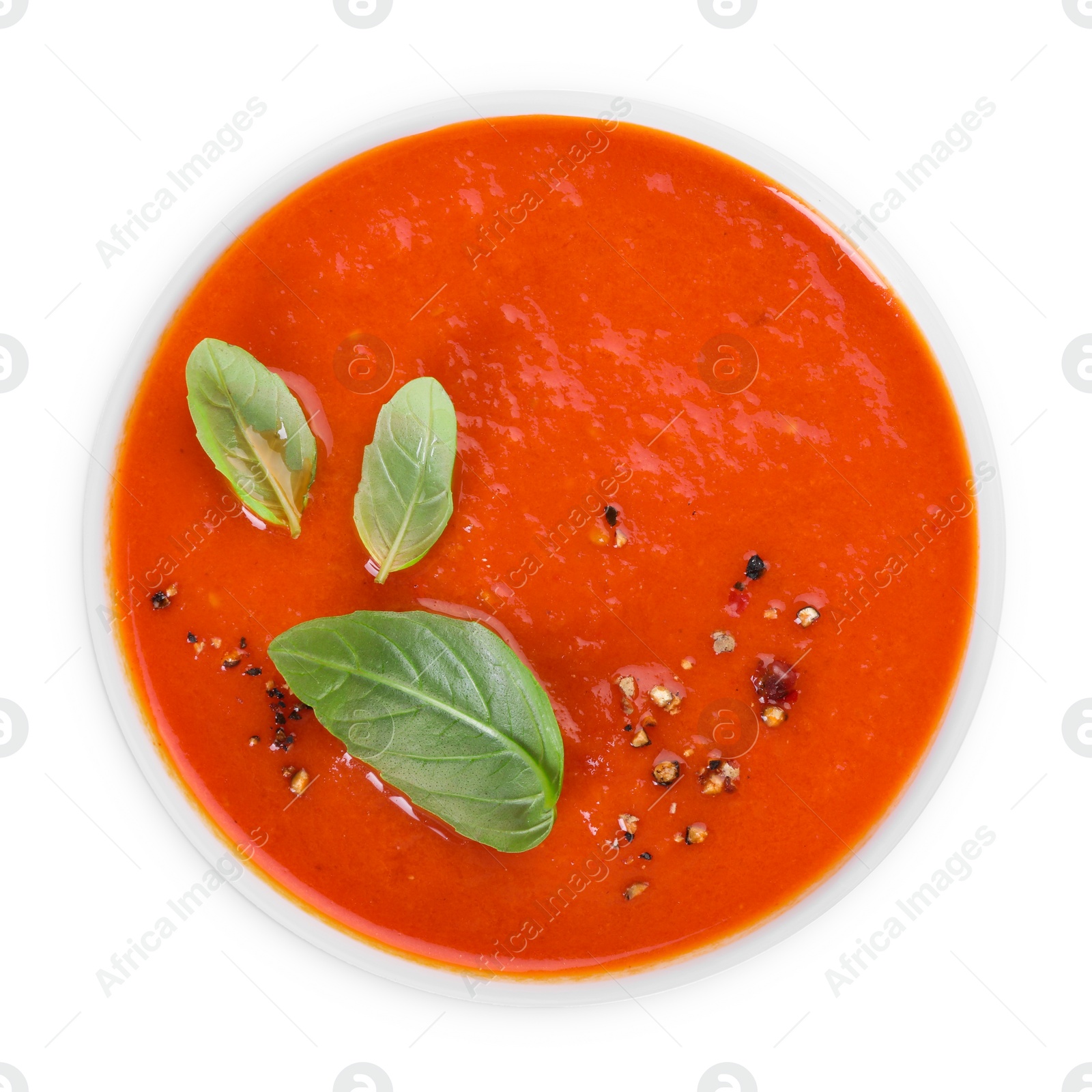 Photo of Delicious tomato soup with basil and spices isolated on white, top view