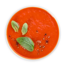 Photo of Delicious tomato soup with basil and spices isolated on white, top view