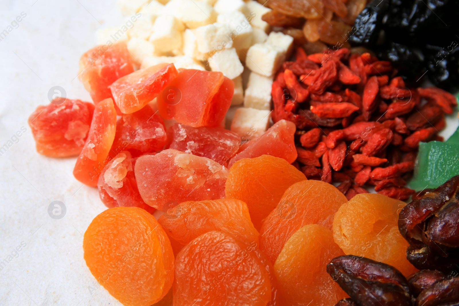 Photo of Pile of different dried fruits on white background, closeup