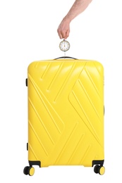 Man weighing stylish suitcase on white background