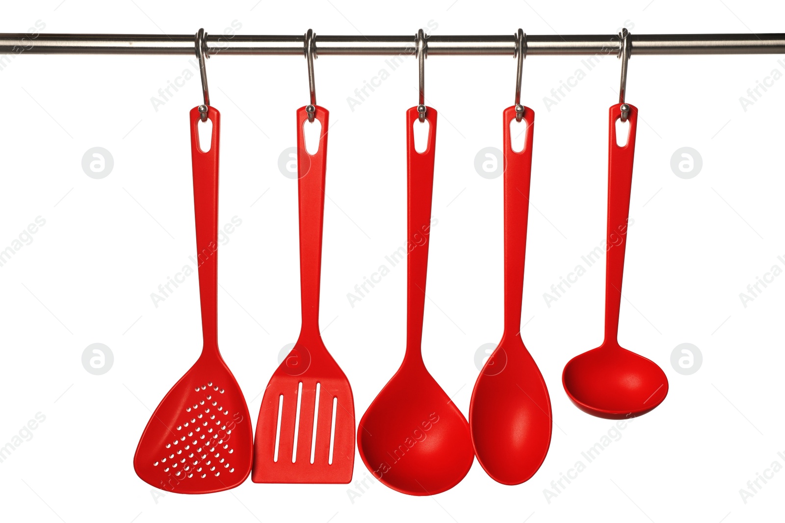 Photo of Set of kitchen utensils hanging against white background