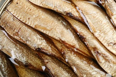 Canned sprats in oil as background, closeup view