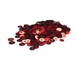 Photo of Pile of red sequins isolated on white