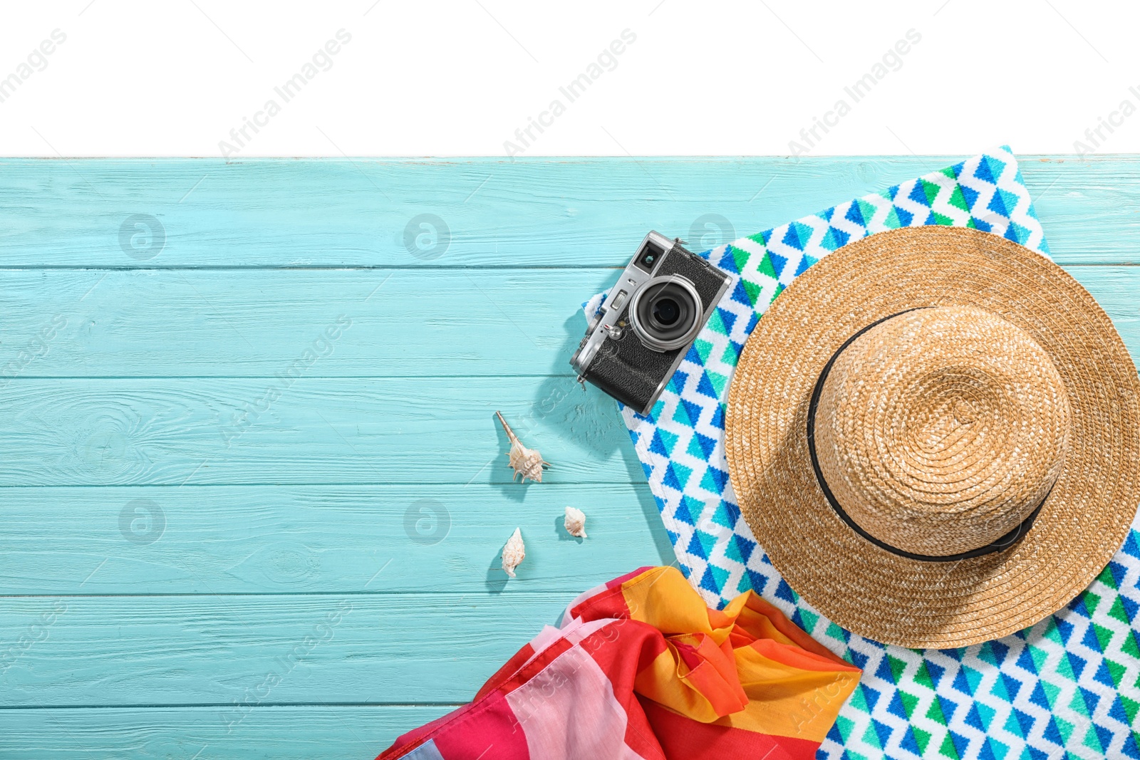 Photo of Flat lay composition with beach accessories on wooden background. Space for text