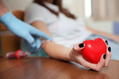 Teenager donating blood in hospital, closeup view