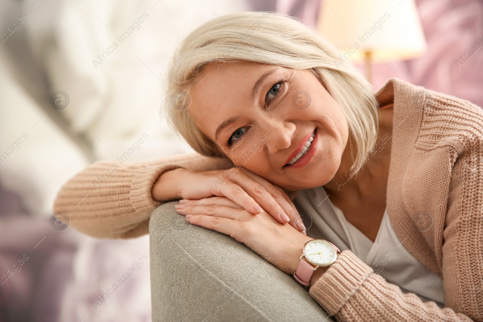 Photo of Beautiful mature woman on sofa at home