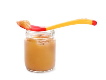 Jar and spoon with healthy baby food on white background