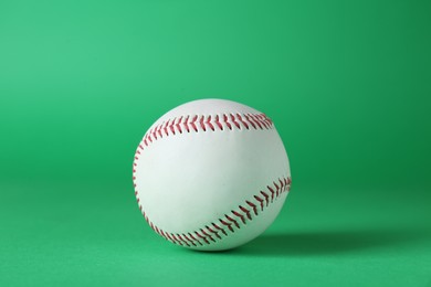 Photo of Baseball ball on green background, closeup. Sports game