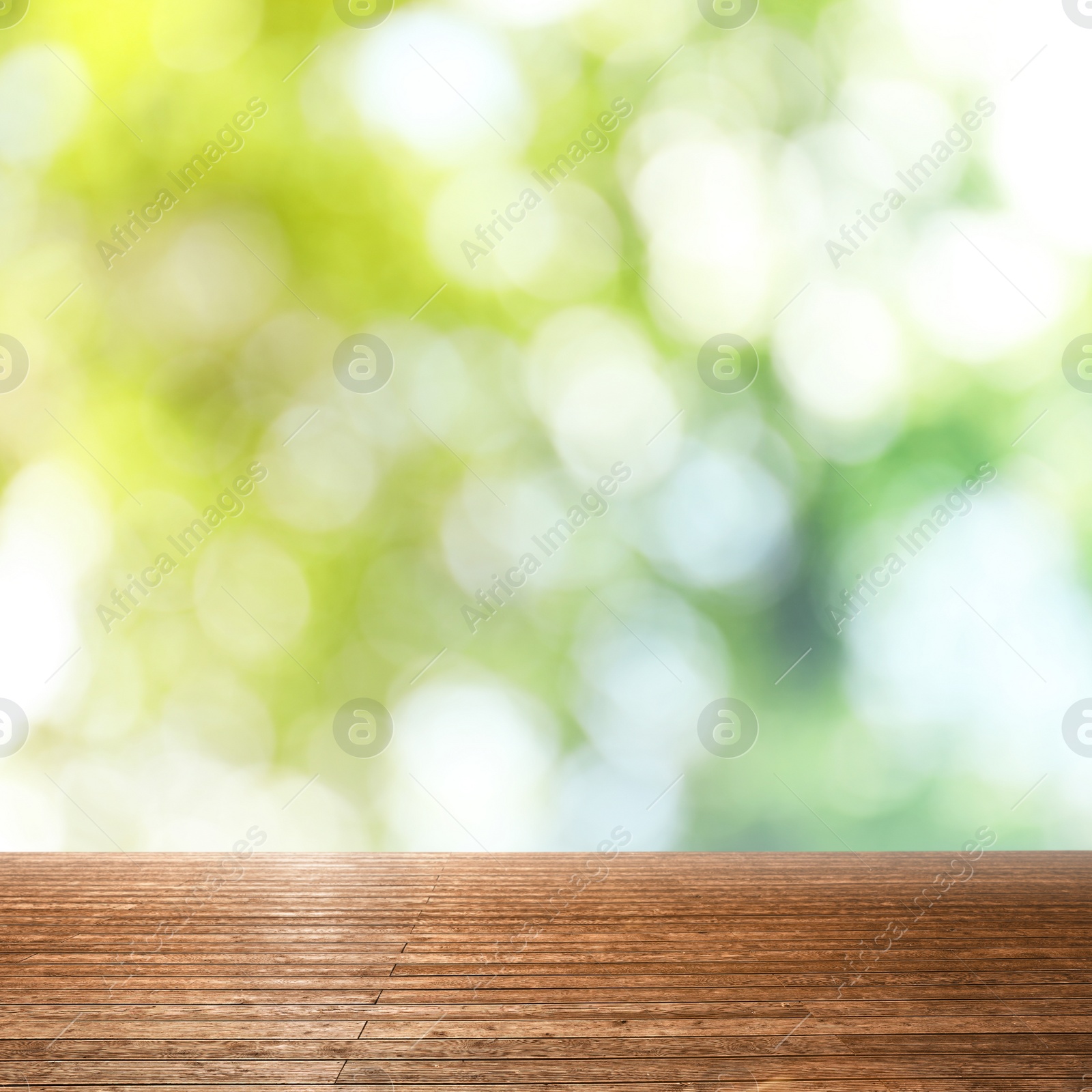 Image of Empty wooden surface against blurred green background. Bokeh effect