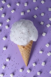 Photo of Sweet cotton candy in waffle cone surrounded by marshmallows on purple background, flat lay