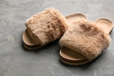 Pair of soft slippers on grey background