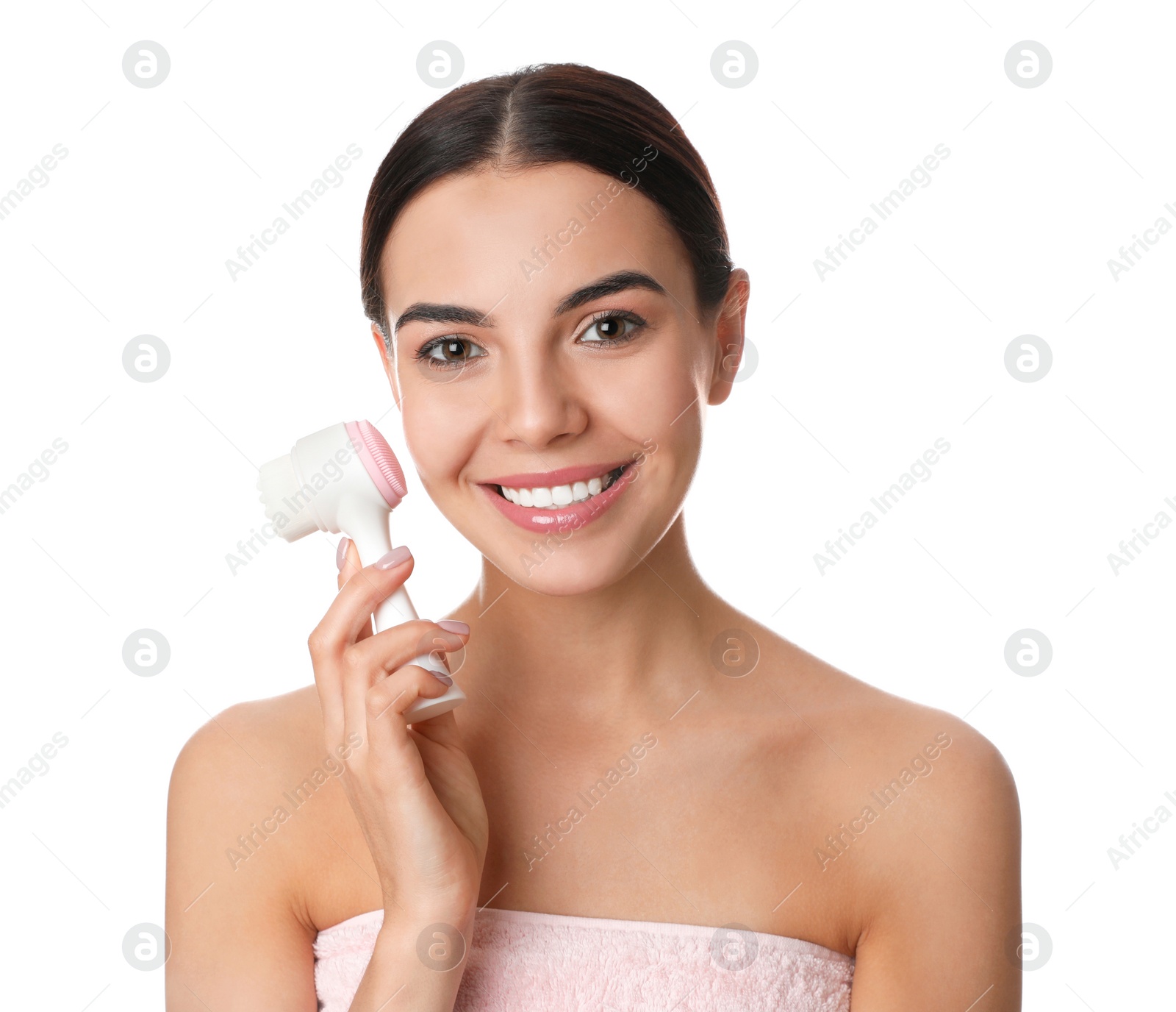 Photo of Young woman using facial cleansing brush on white background. Washing accessory