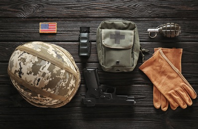 Photo of Set of military outfit on dark wooden background, flat lay