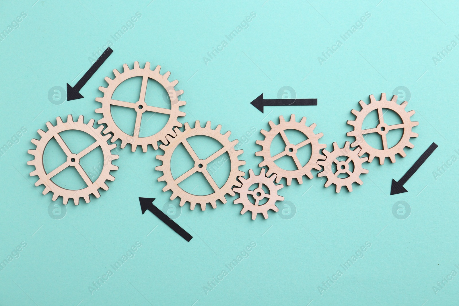 Photo of Business process organization and optimization. Scheme with wooden figures and arrows on light blue background, top view