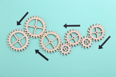 Business process organization and optimization. Scheme with wooden figures and arrows on light blue background, top view