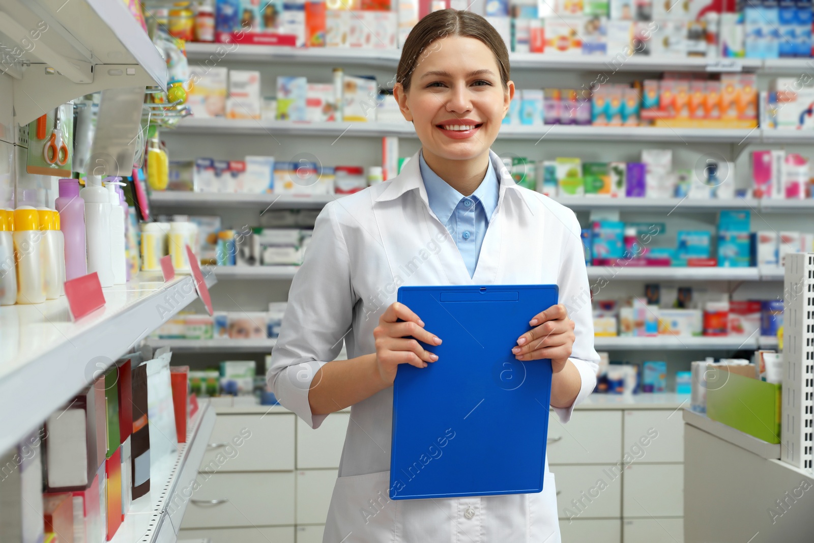 Image of Professional pharmacist with clipboard in modern drugstore