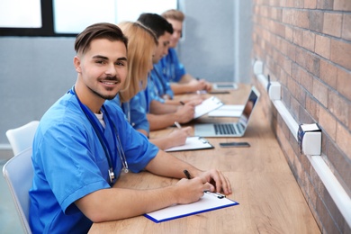 Medical student with groupmates studying in university