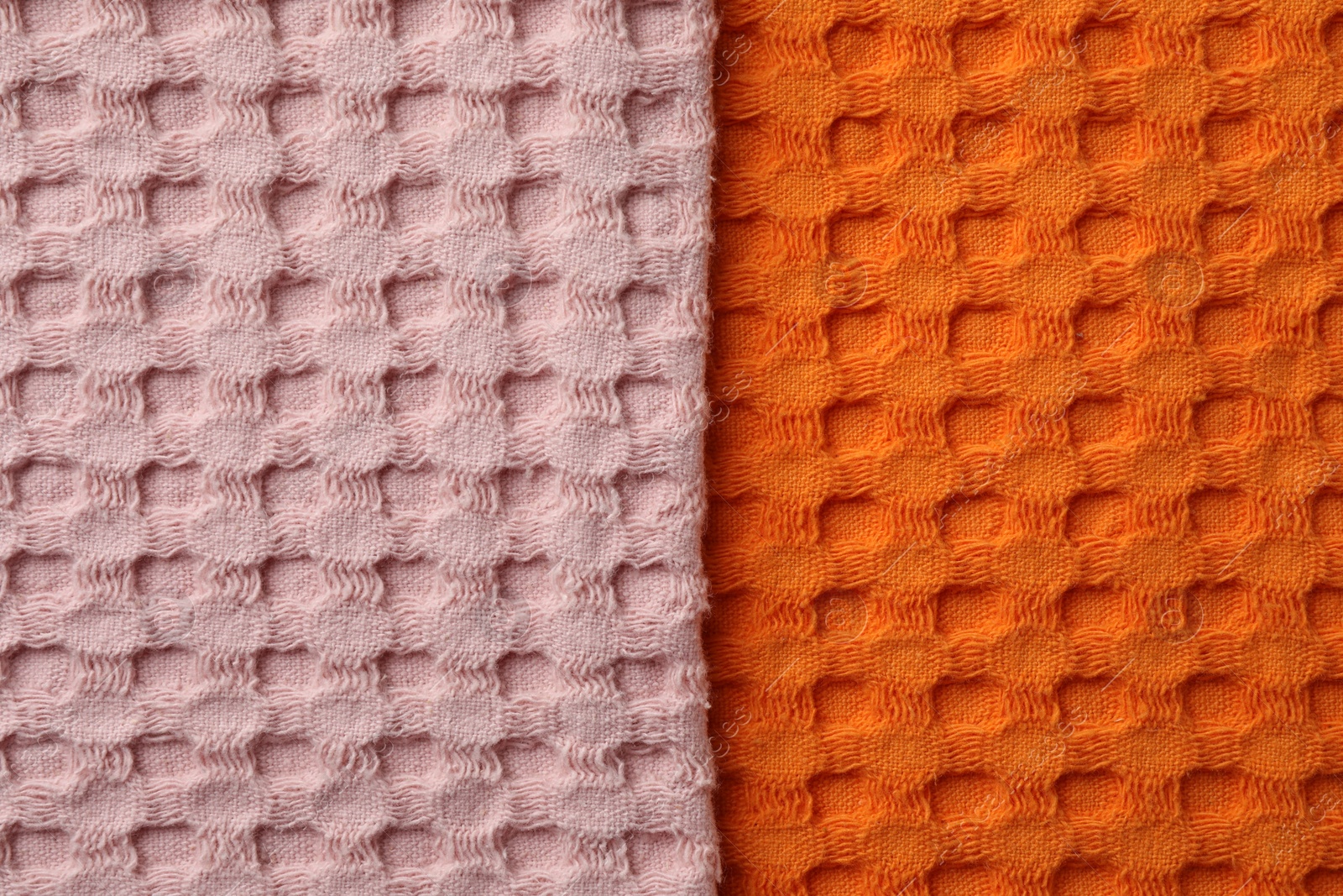 Photo of Orange and pink fabrics as background, top view