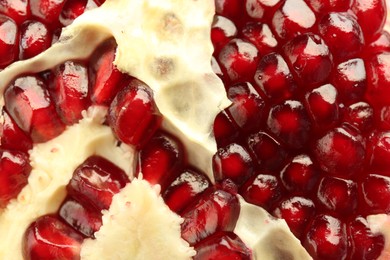 Photo of Ripe juicy pomegranate grains as background, closeup